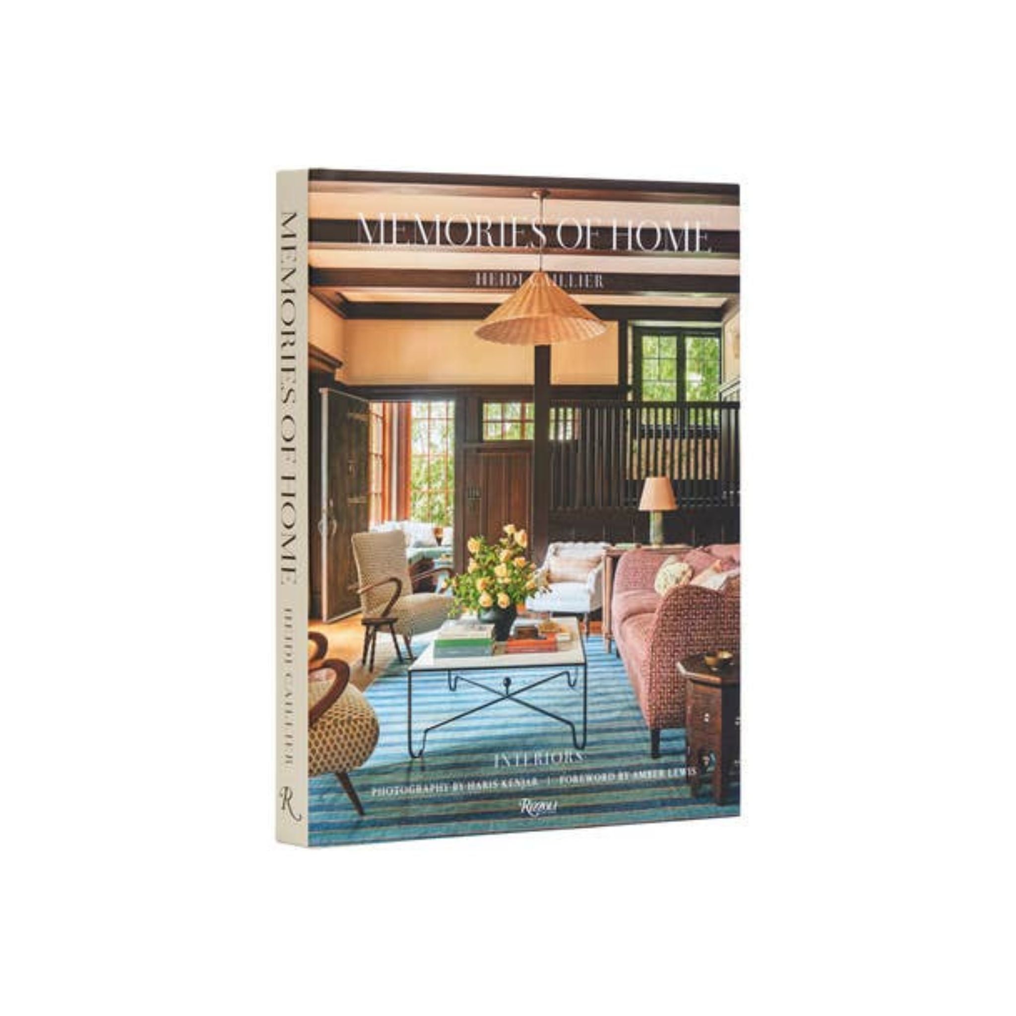 This image features the cover of a coffee table book titled "Memories of Home" by Heidi Caillier. The cover captures a cozy and stylish interior scene, showcasing a well-designed living space with a mix of traditional and modern elements.