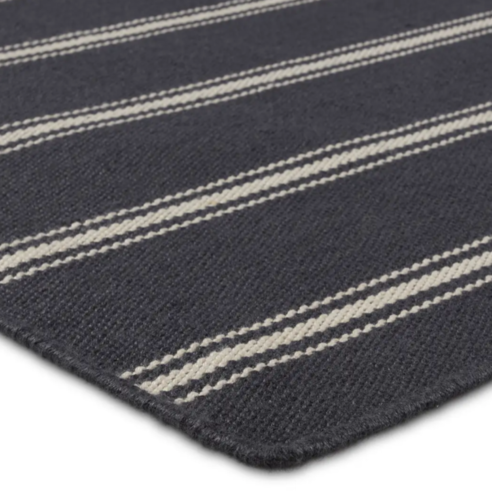 Navy stripe rug with handwoven flatwoven PET yarns, featuring thin and thick navy and ivory stripes, low 1/3" pile, durable polypropylene backing.