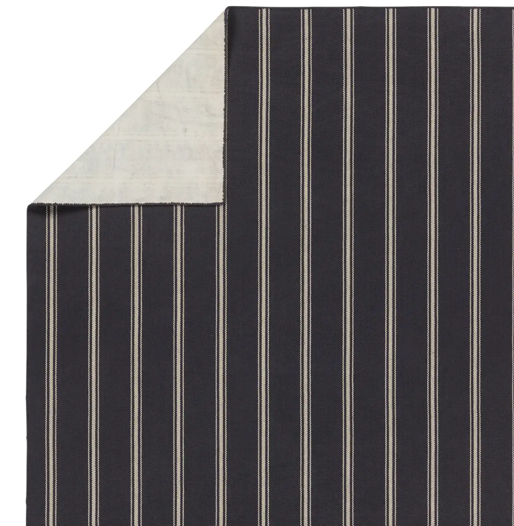 Navy stripe rug with handwoven flatwoven PET yarns, featuring thin and thick navy and ivory stripes, low 1/3" pile, durable polypropylene backing.