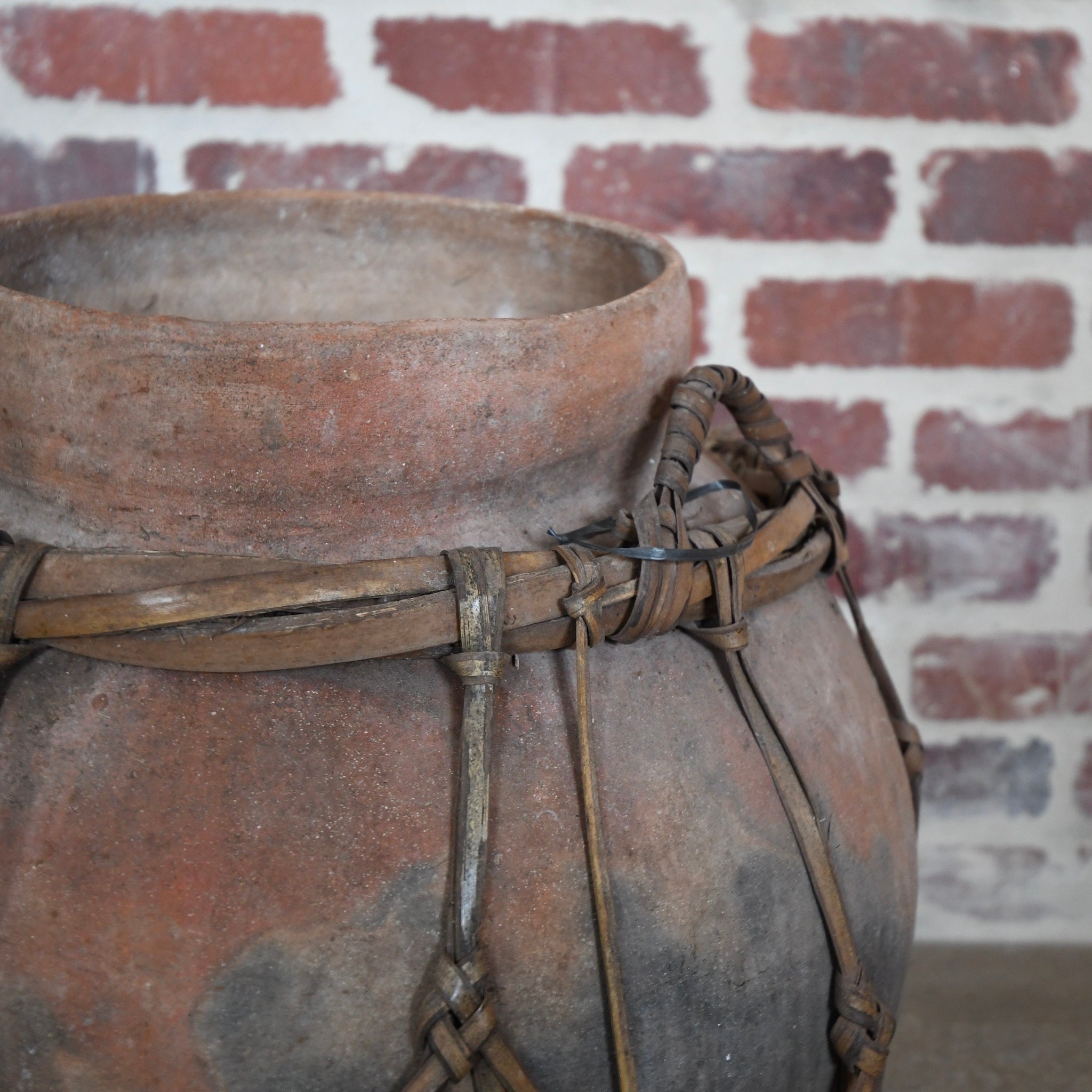 terracotta vessel with braided handles.