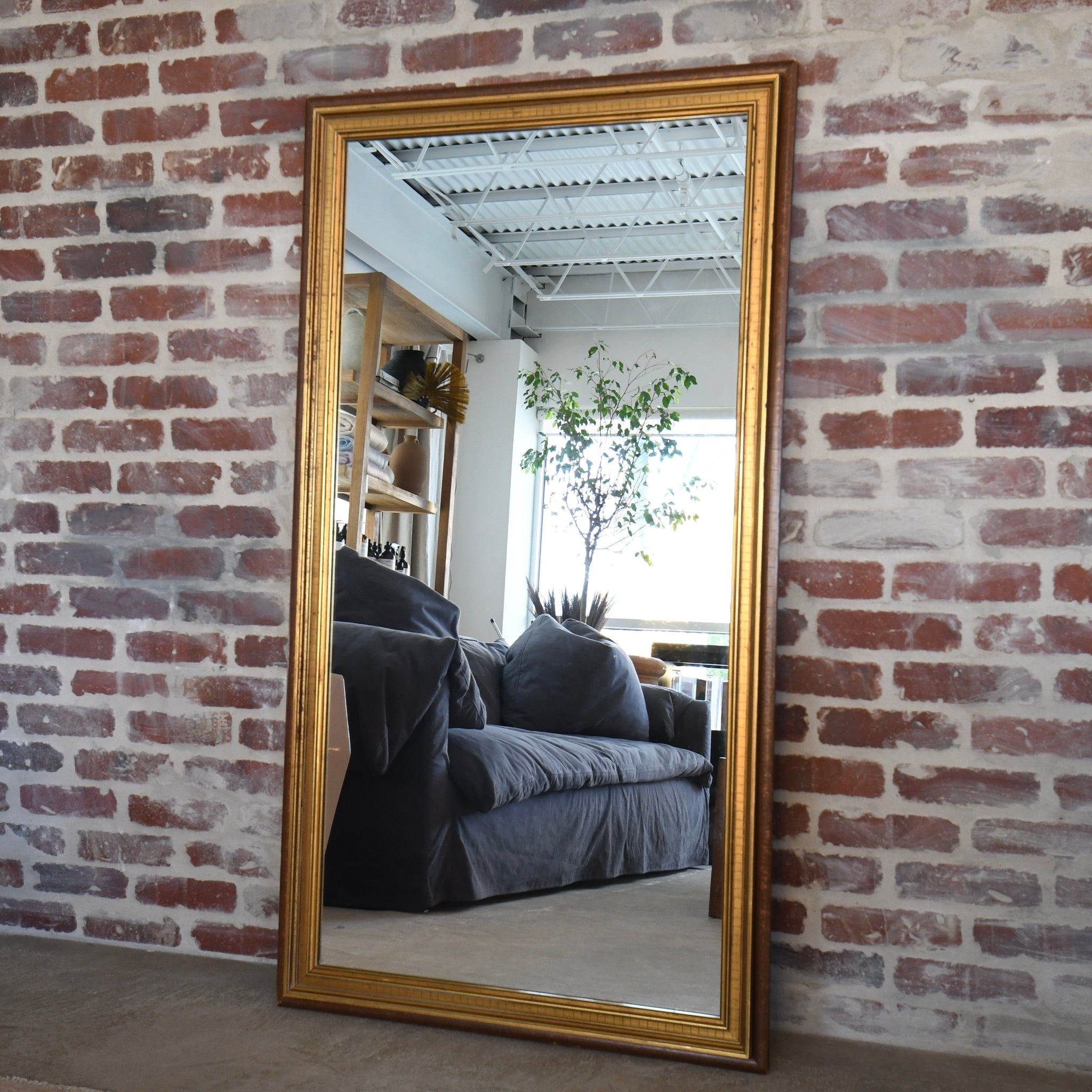 Vintage rectangular mirror with patinated wood frame and gold accents, versatile for horizontal or vertical display, perfect for antique home décor.