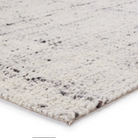Woven white and grey rug with basket weave texture, handwoven wool, neutral ivory and charcoal gray tones, plush and durable.