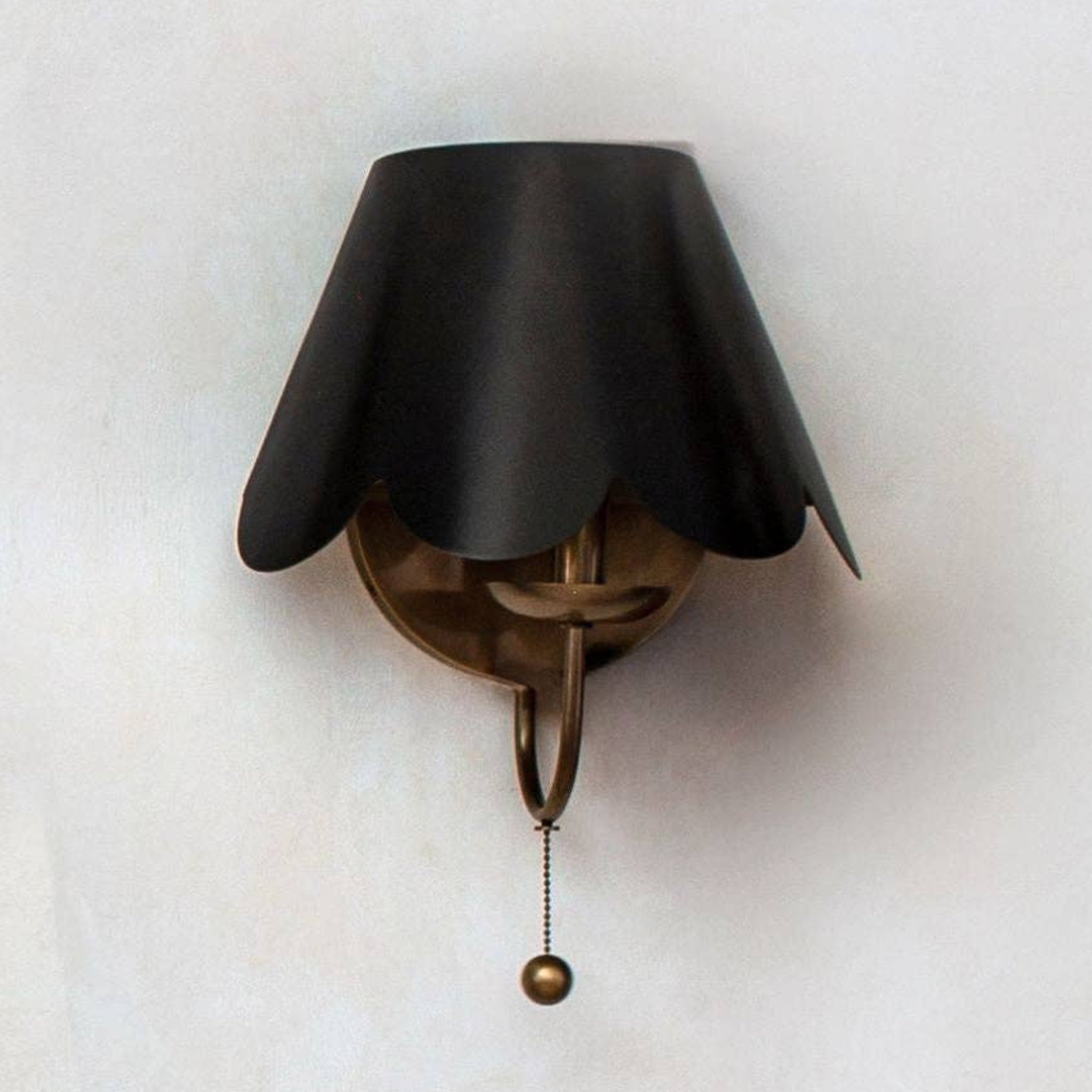 Dahlia Sconce antique bronze finish black sculpted shade.