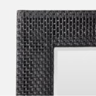 Onyx peeled rattan mirror enhancing modern decor.