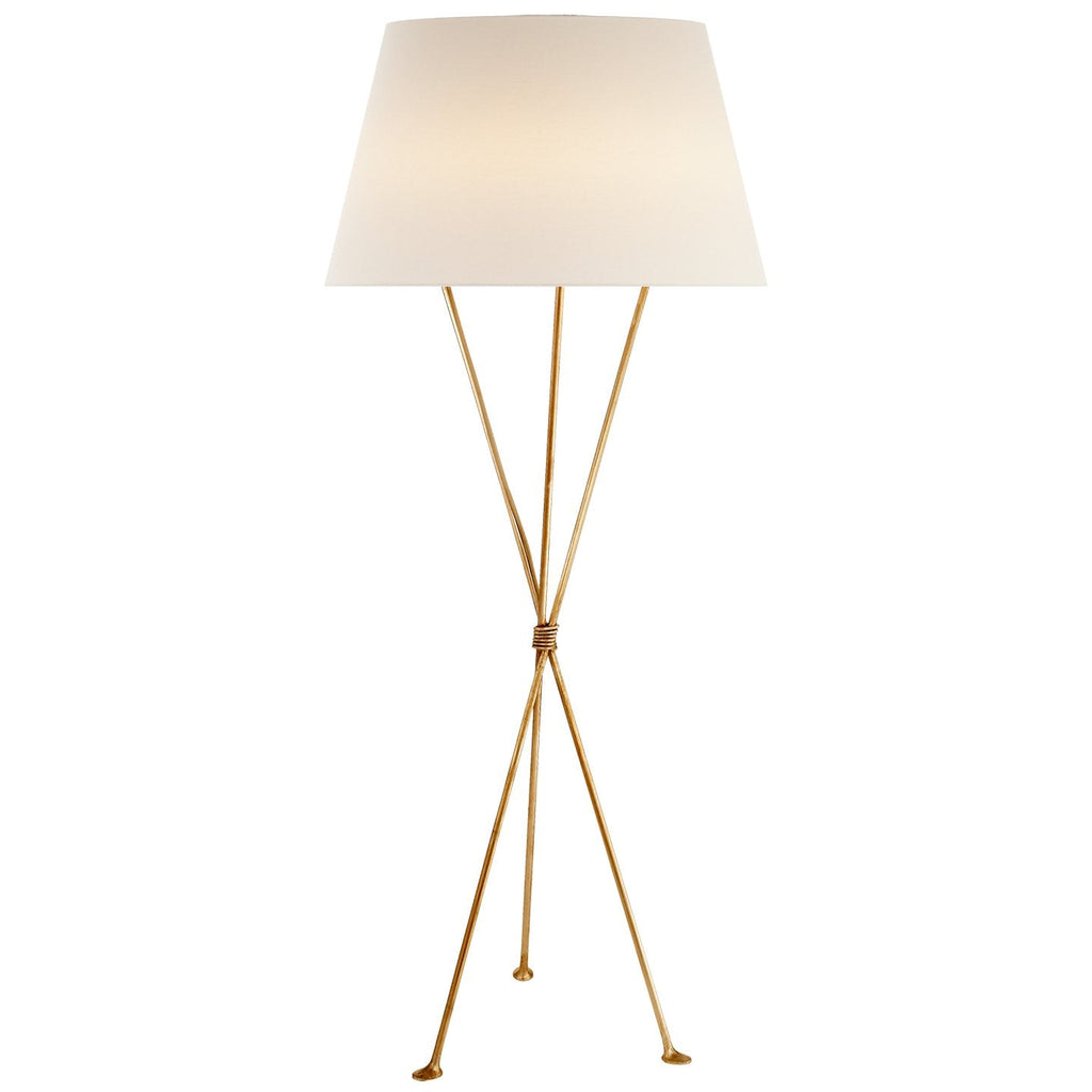 "62" Brass Floor Lamp by Aerin Lebon casting warm light"