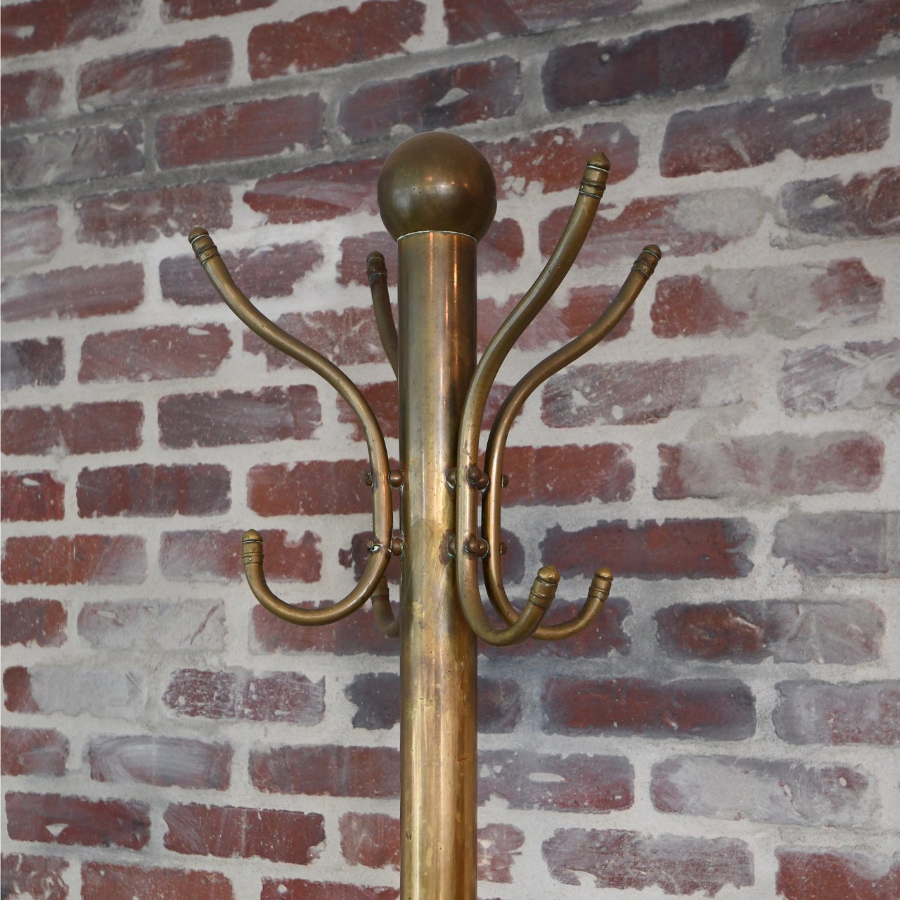 Classic Brass Coat Rack in entryway with purses and coats