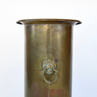 Vintage umbrella holder in antique brass finish.