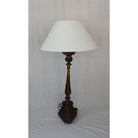 Vintage Copper Floor Lamp casting warm light in a rustic setting.