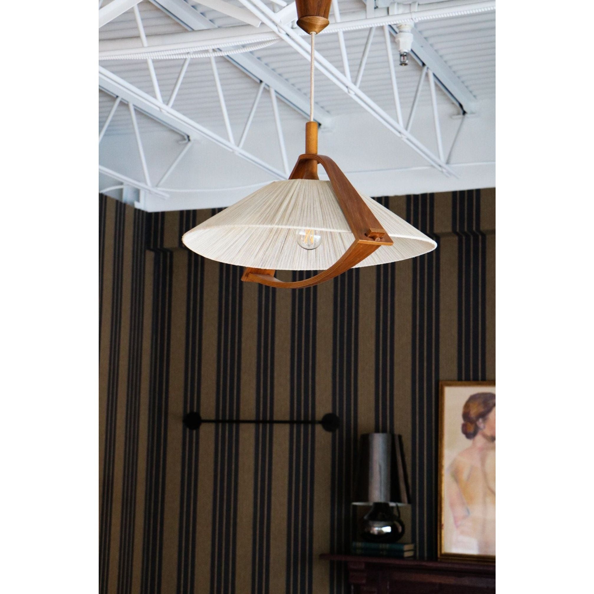 "Antique Hanging Woven Wood Pendant Light illuminating a rustic living room"