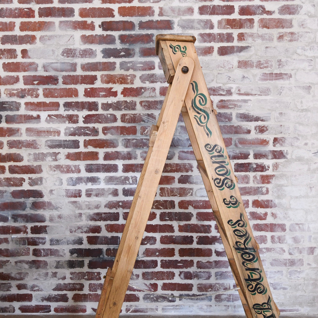 "Vintage Wooden Ladder serving as a towel rack in a farmhouse bathroom"