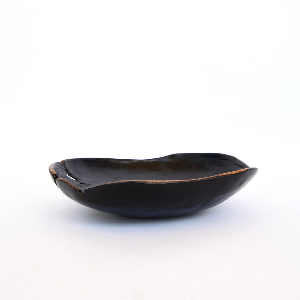 A hand made Black Texture bowl with an irregular rim by Golden Oldies on a white background.