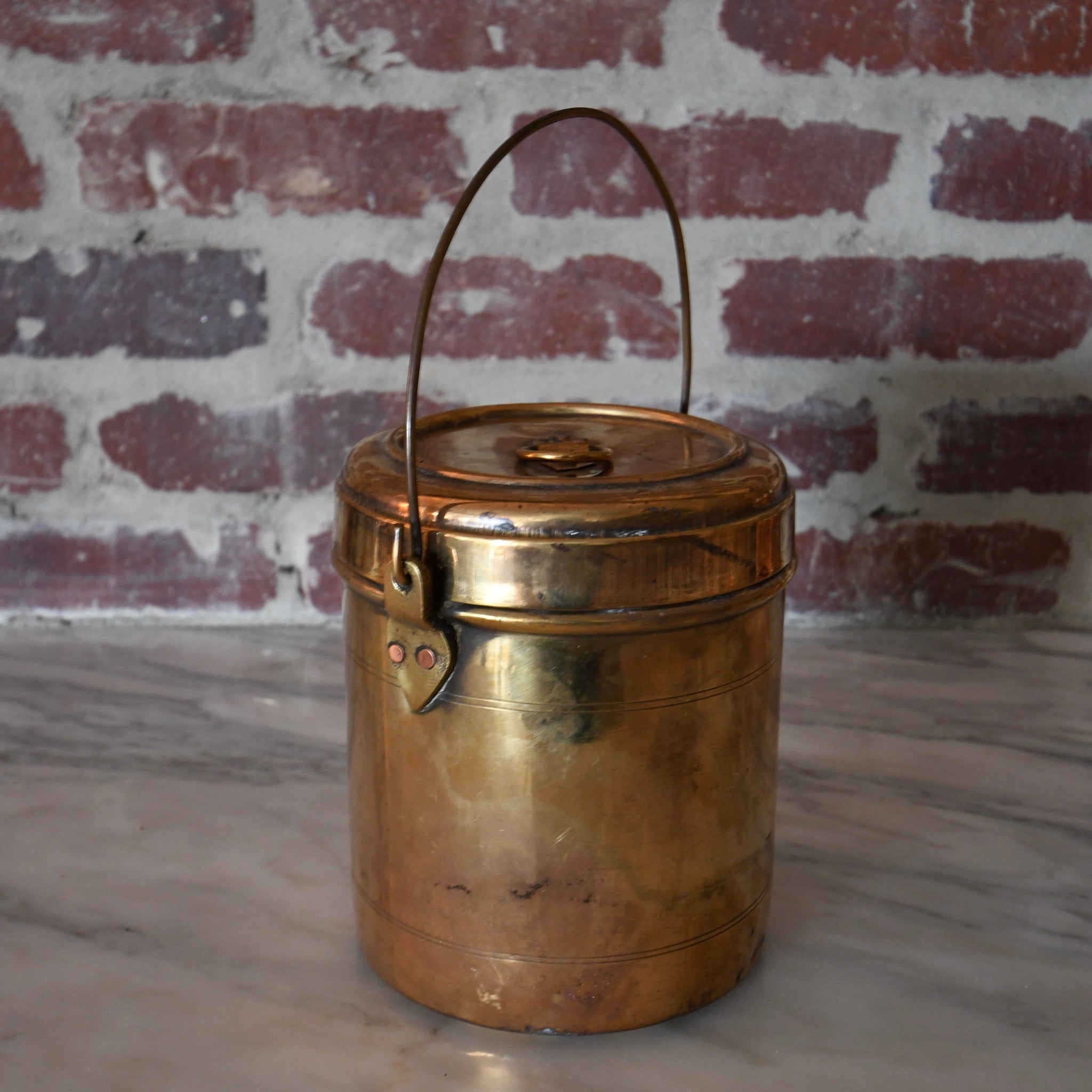 brass bharni pot with lid and handle.