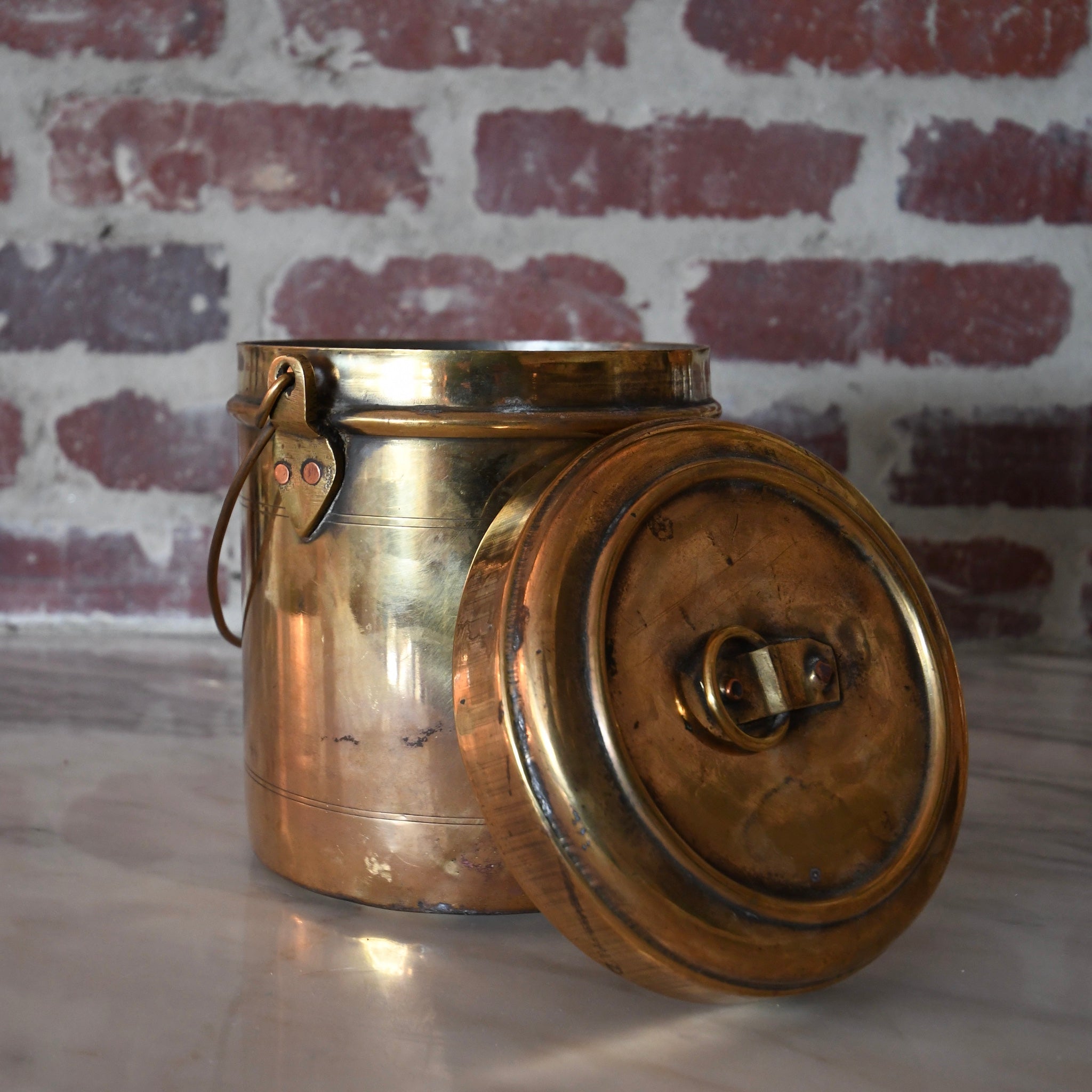 brass bharni pot with lid and handle.