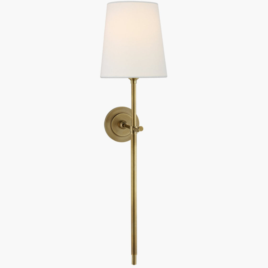 Hand-rubbed antique brass sconce featuring standard linen shade.