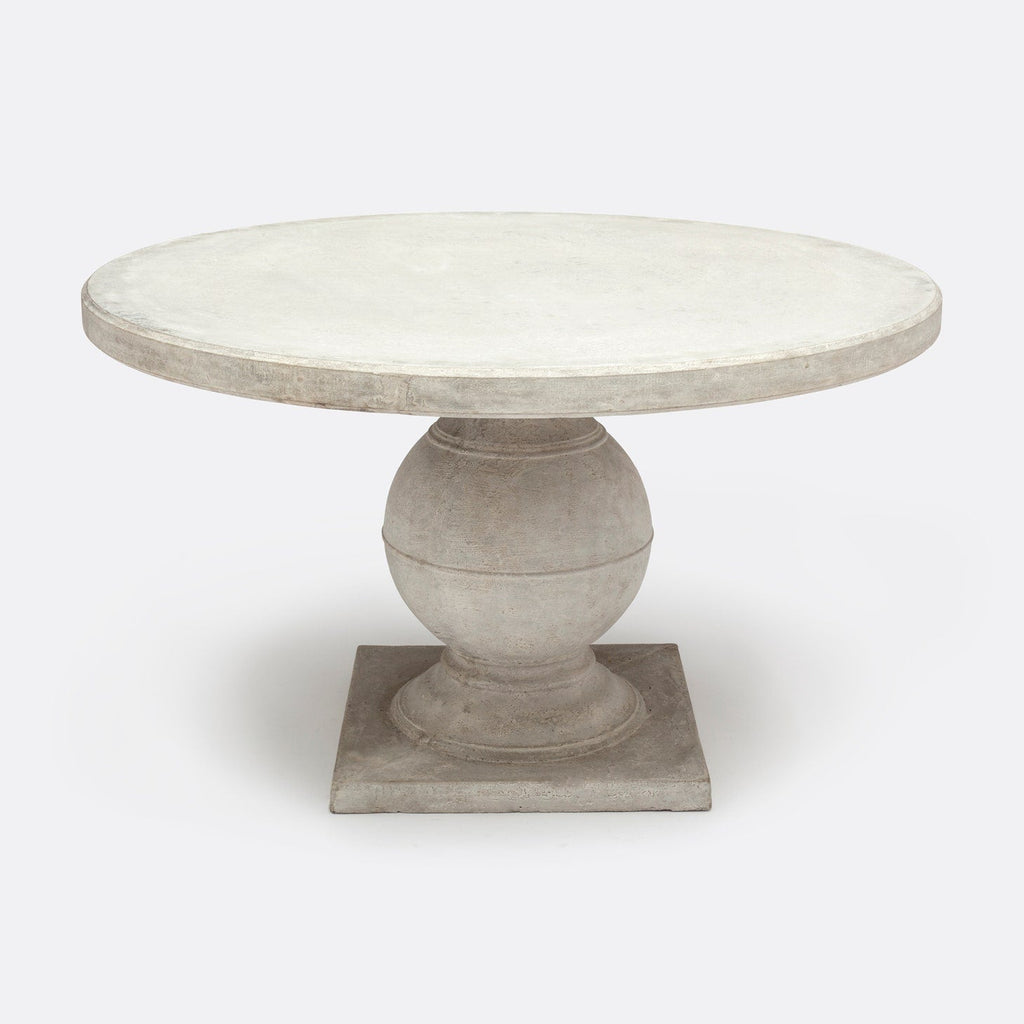 Elegant light gray Cyril Stone dining table in a modern outdoor setting