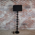 "Hugo Black Wood Barbell Floor Lamp in a contemporary living room"