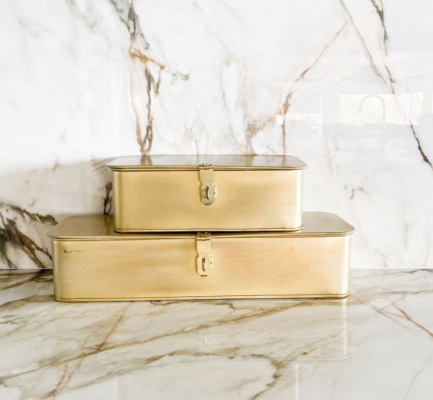 Brass metal storage box with decorative lid for shelves, modern home decor accessory.