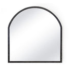 Luxurious leather arched mantle mirror over a fireplace.