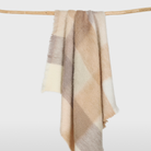 mohair throw blanket in giant buffalo check and warm neutral colors.