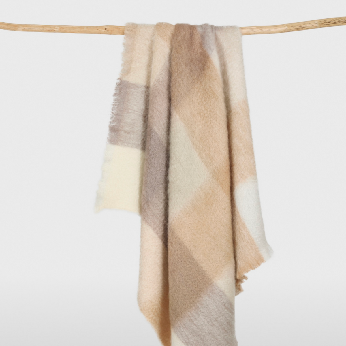 mohair throw blanket in giant buffalo check and warm neutral colors.