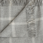 100% Merino lambswool throw with classic windowpane pattern in neutral tones.