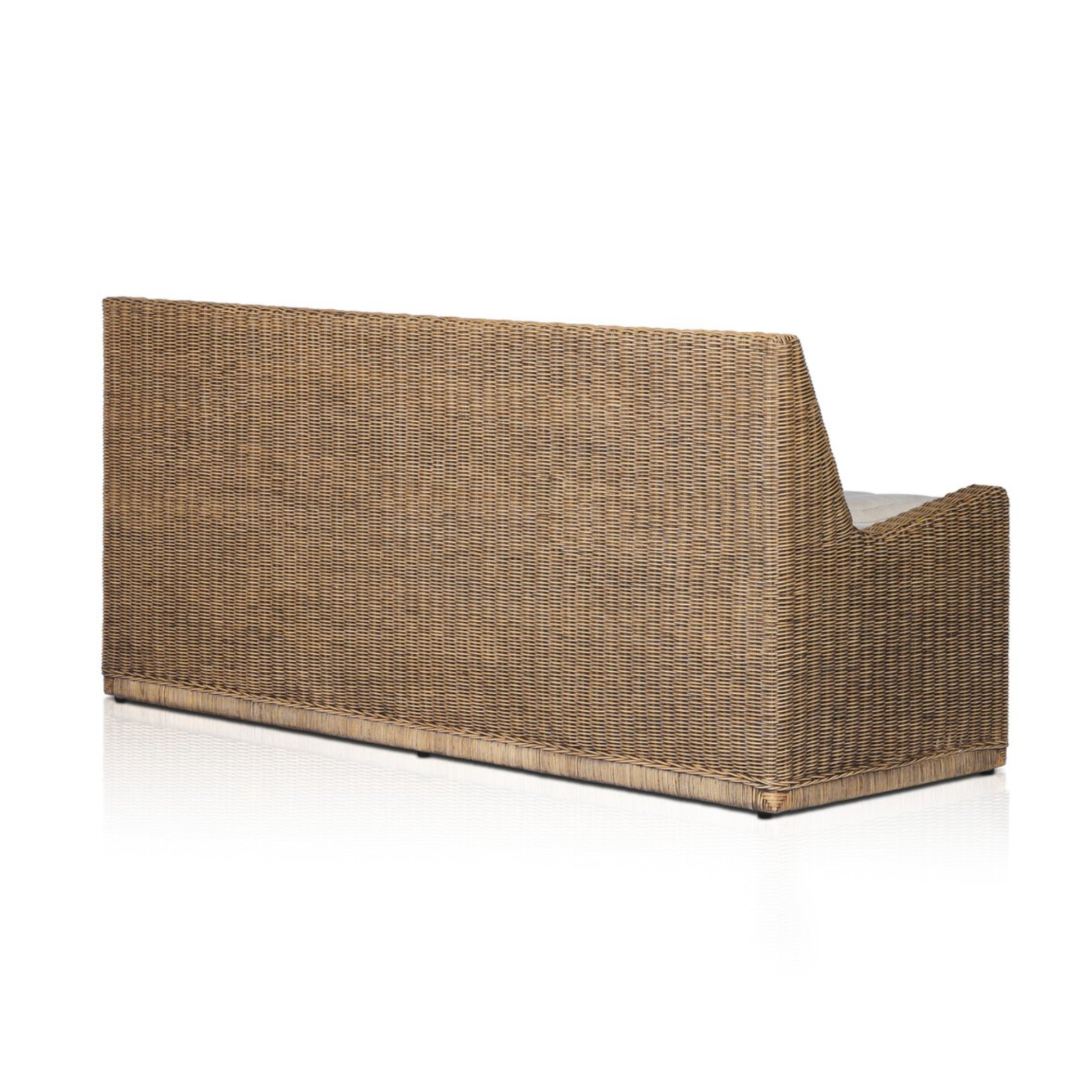 Left arm facing large dining bench with woven natural brown rattan frame, flax/linen cushion in Broadway Dune, 72 inches wide, ideal for relaxed dining.