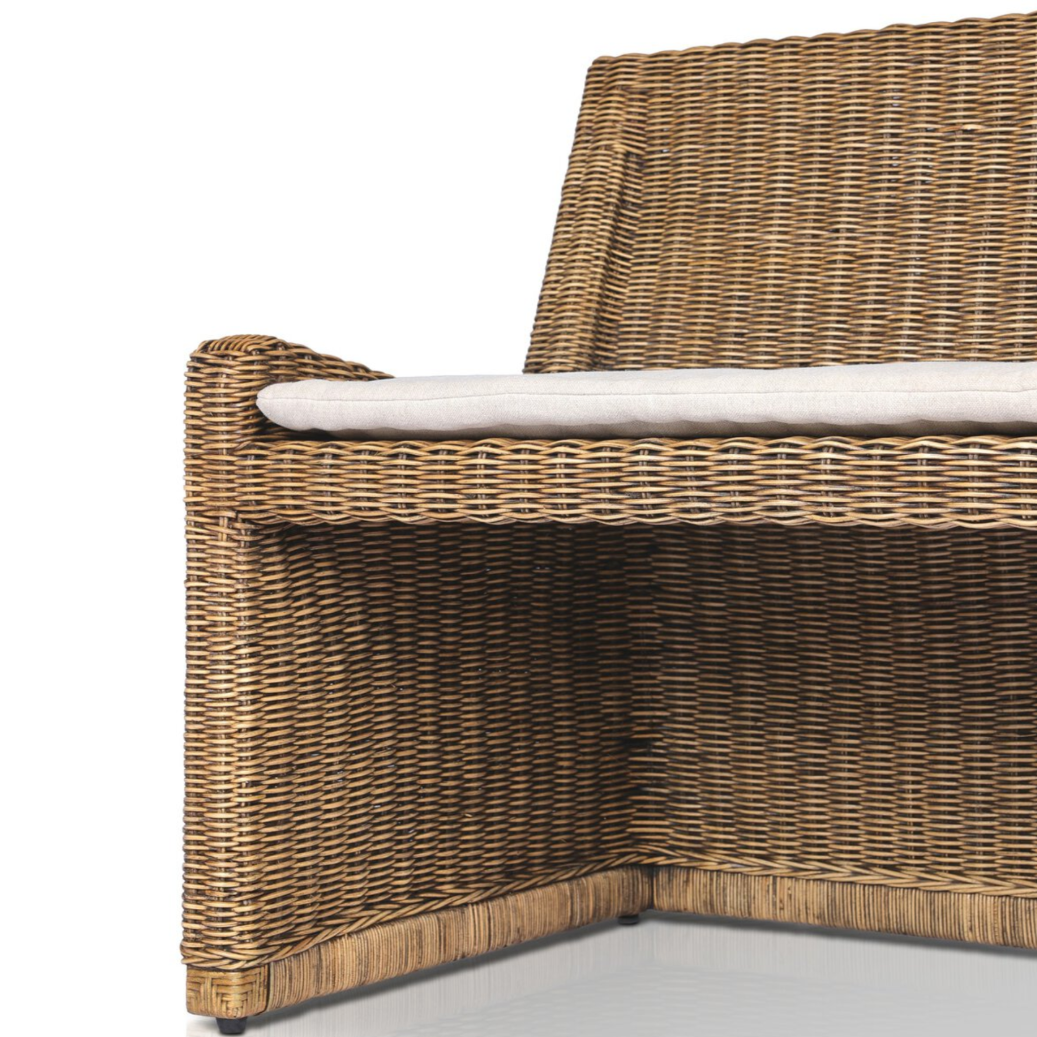 Left arm facing small dining bench with natural woven brown rattan frame and flax/linen cushion in Broadway Dune, 49 inches wide.