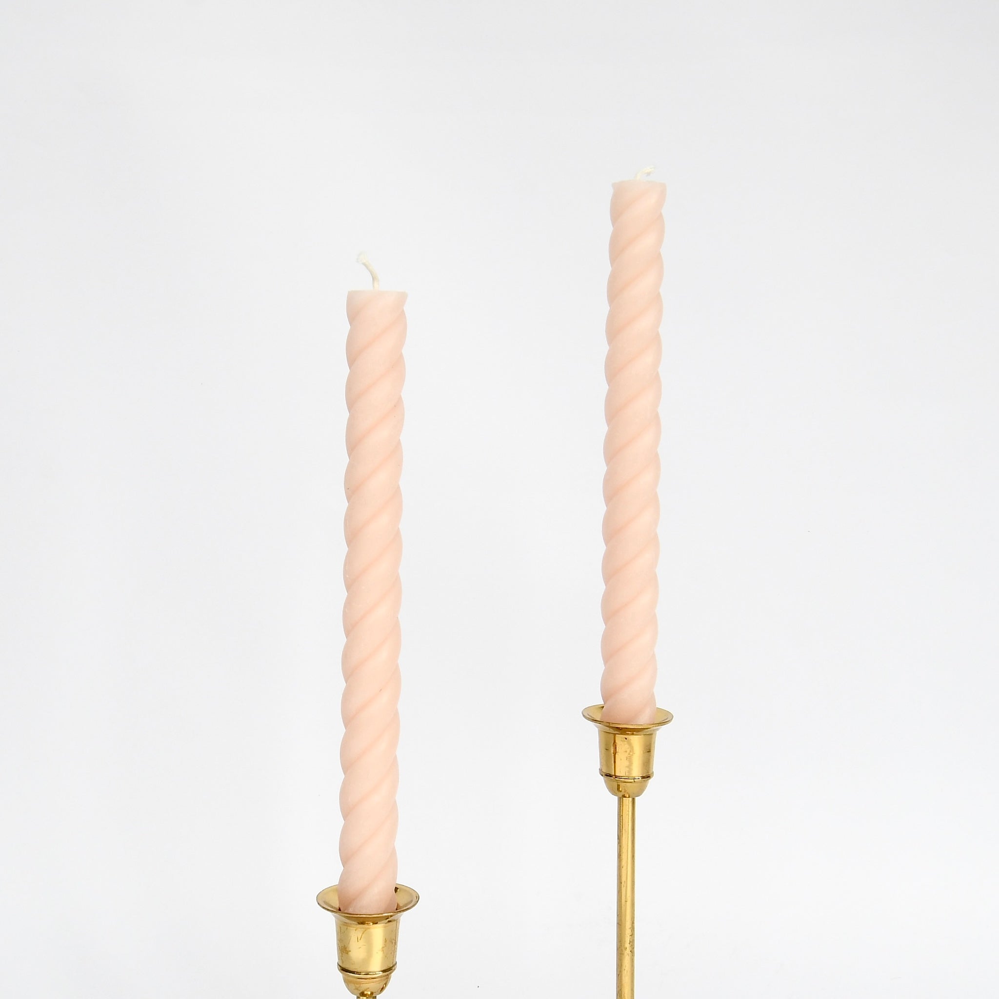 Set of two blush 10" twisted rope taper candles, hand-poured from pure beeswax in New York, burn clean and bright.
