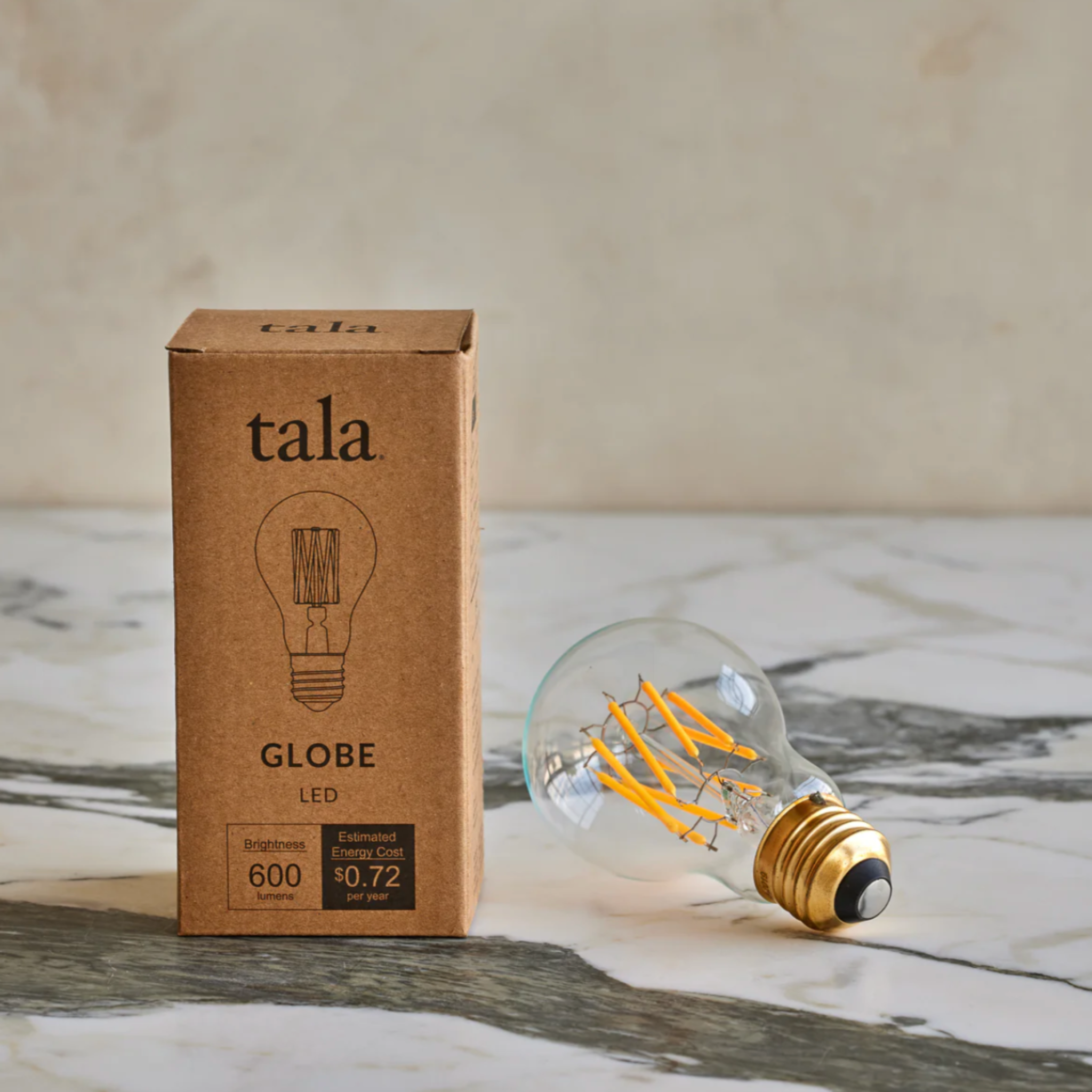 Tala Globe LED lightbulb, 6W clear round bulb with 600 lumens and warm 2500K color temperature, ideal for energy-efficient modern lighting.
