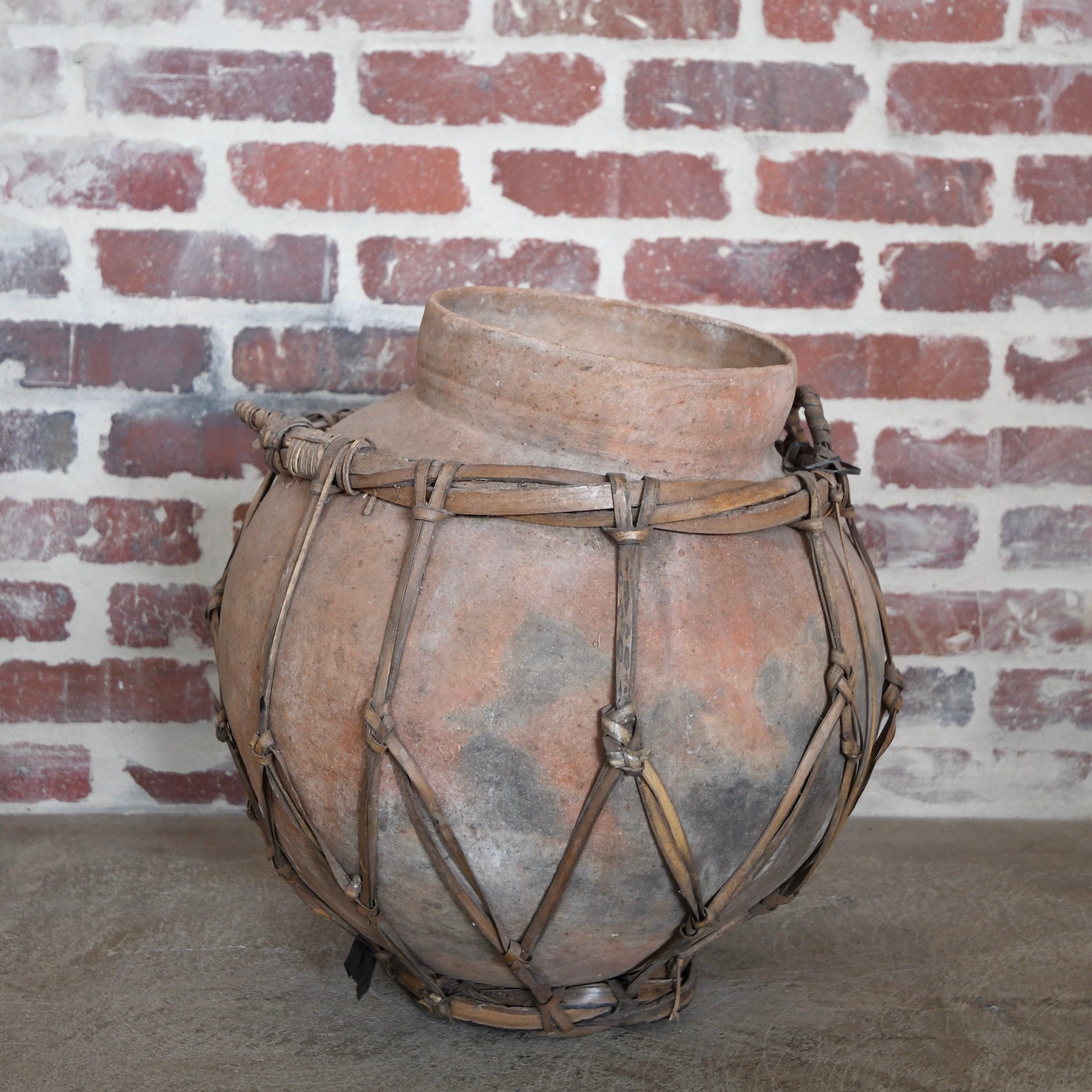 terracotta vessel with braided handles.