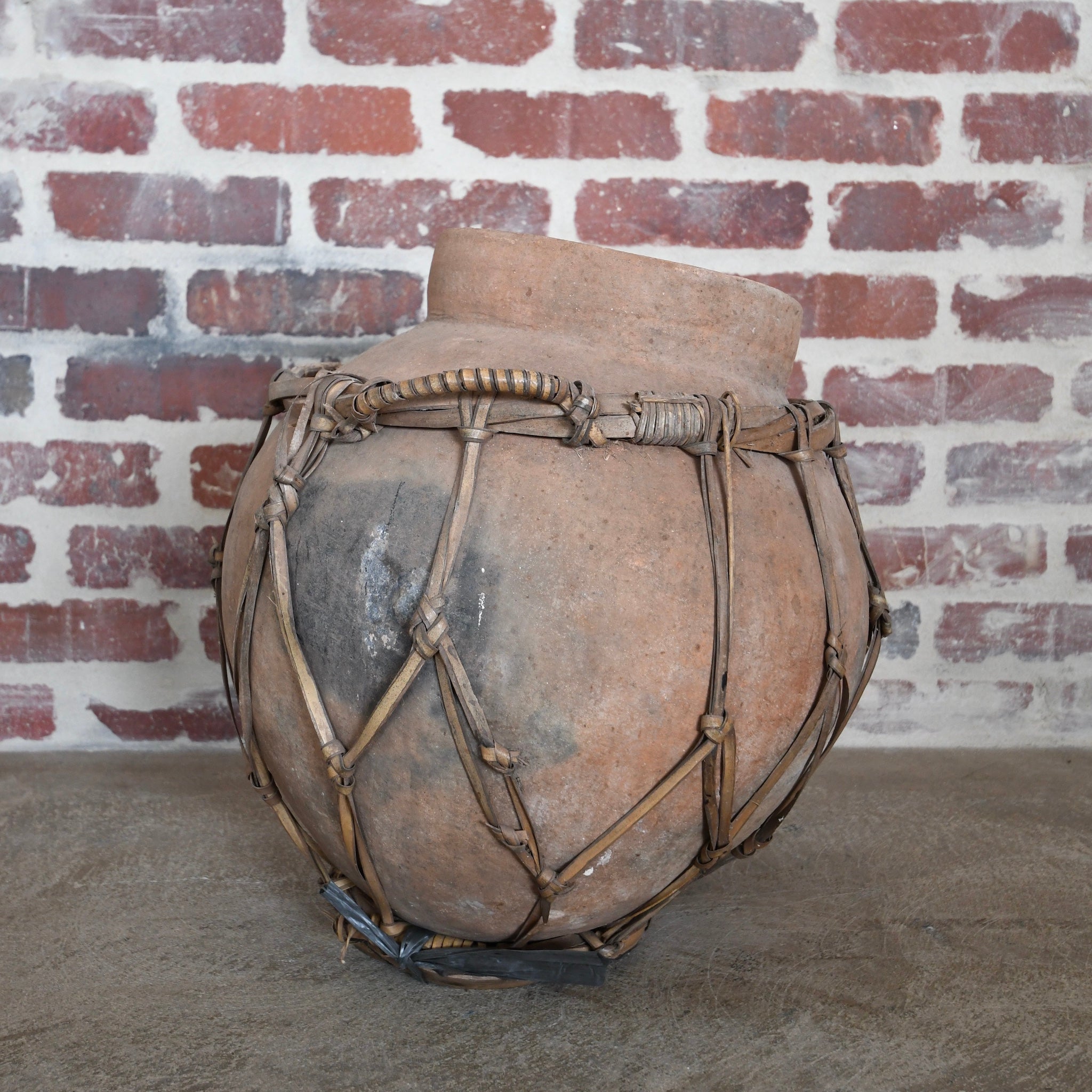 terracotta vessel with braided handles.