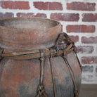 terracotta vessel with braided handles.