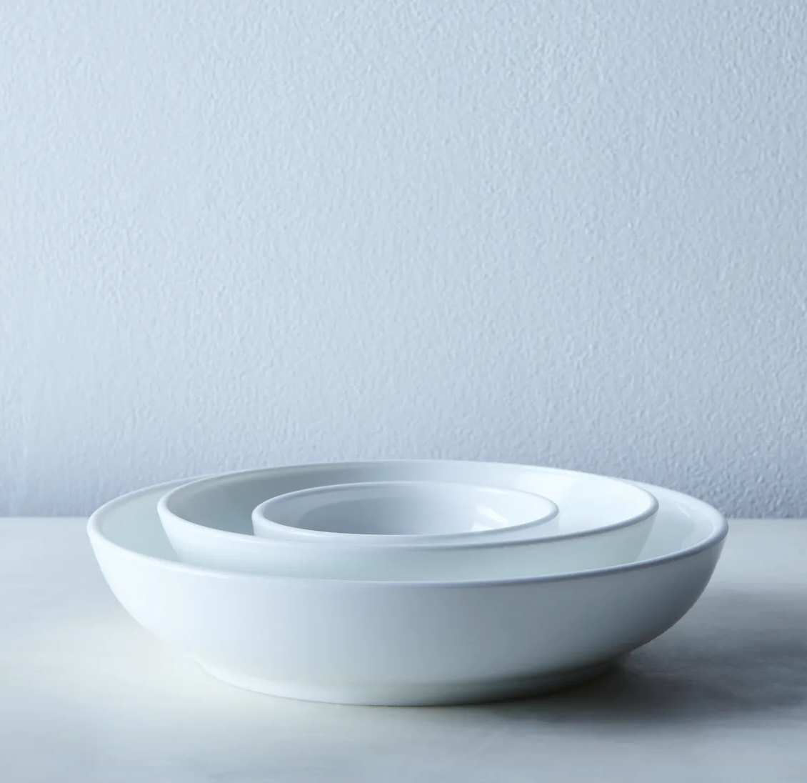 Set of three vintage milk glass nesting bowls by Mosser Glass, elegant translucent white kitchenware for serving and display.