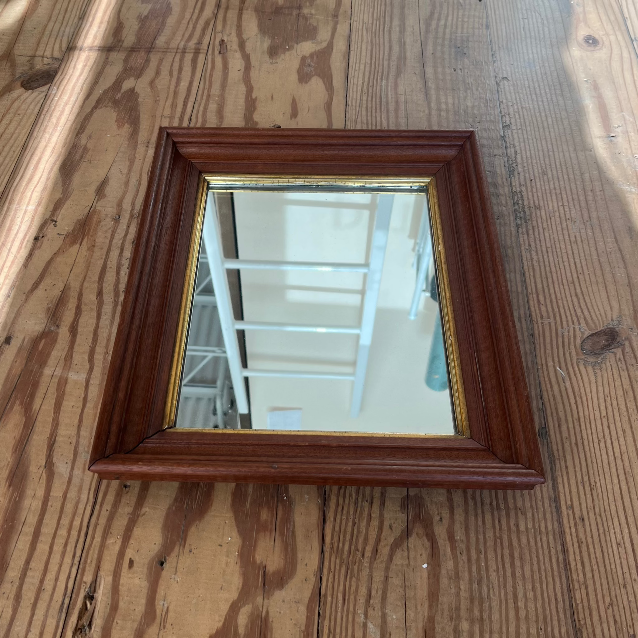 rectangular wood framed mirror with gold accent